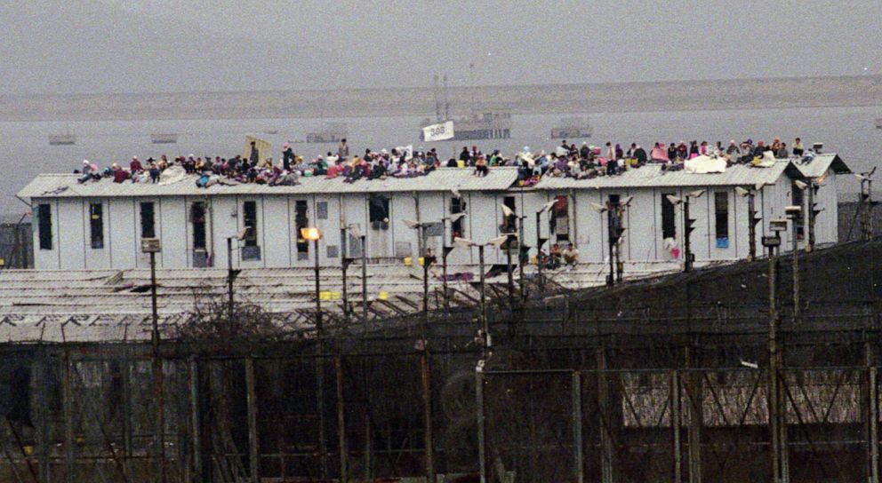 PHOTO: An estimated 100 Vietnamese detainees stage a rooftop protest at Hong Kong's Whitehead Detention Center, May 10, 1996, after about 200 Vietnamese inmates escaped from the camp earlier in the morning.