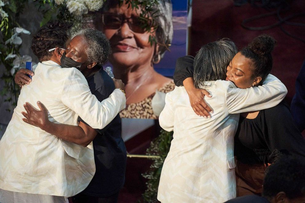 Angela Crawley, left, and Robin Harris, second right, daughters of Ruth Whitfield, greet mourners during Whitfield's funeral service in Buffalo, New York on May 28, 2022. Whitfield, 86, was killed in the May 14 Buffalo shooting at Tops Friendly Market.