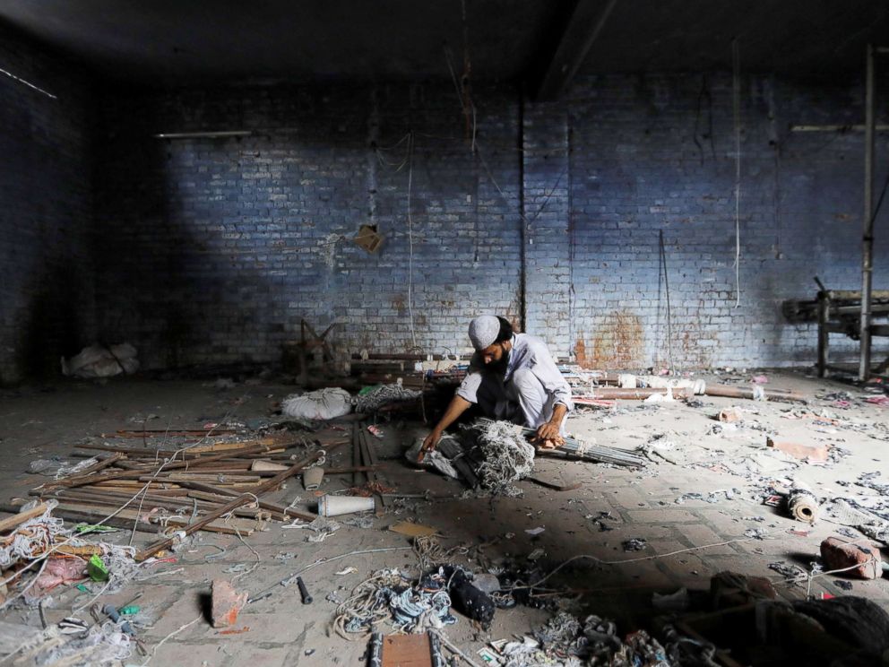 PHOTO: A scrap dealer searches for useful material at a weaving factory, that was shut a year ago, in Panipat, India, Aug. 29, 2018.