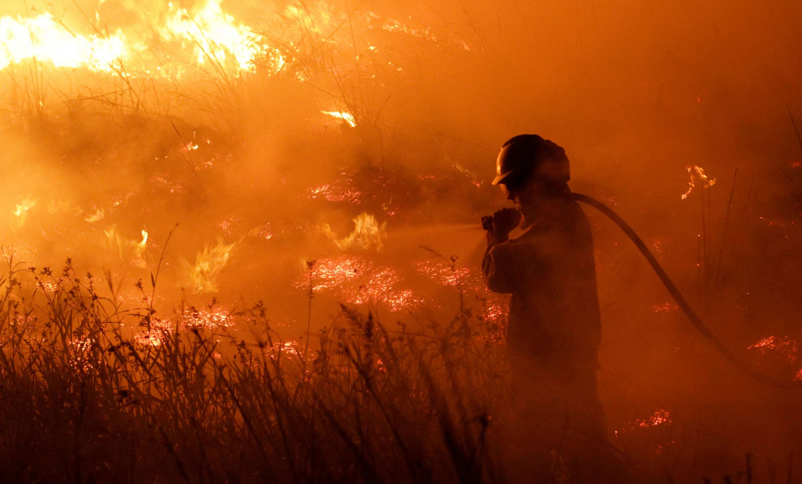 PHOTO: A Firefighter battles a wildfire in the norther province of Corrientes, in Portal San Antonio, Argentina, Feb. 14, 2022.