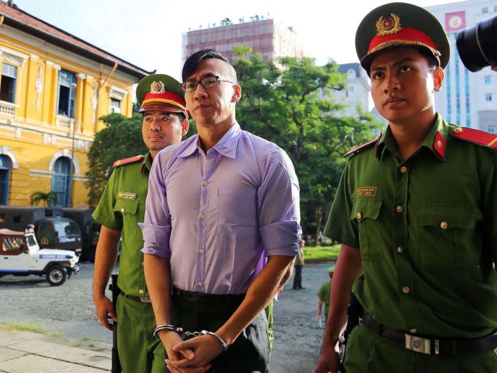 PHOTO: American-Vietnamese citizen William Nguyen (C) is escorted by policemen to a courtroom for his trial in Ho Chi Minh City on July 20, 2018.