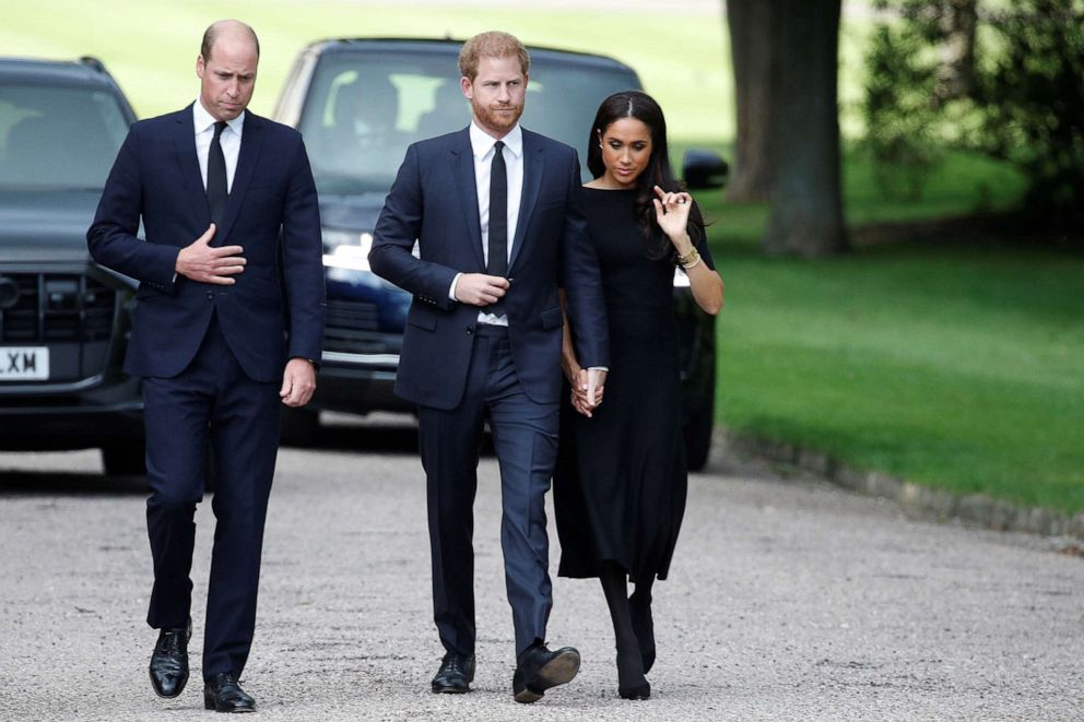 PHOTO: Britain's William, Prince of Wales, Prince Harry and Meghan, the Duchess of Sussex, walk outside Windsor Castle, following the passing of Britain's Queen Elizabeth II, in Windsor, Britain, Sept. 10, 2022.