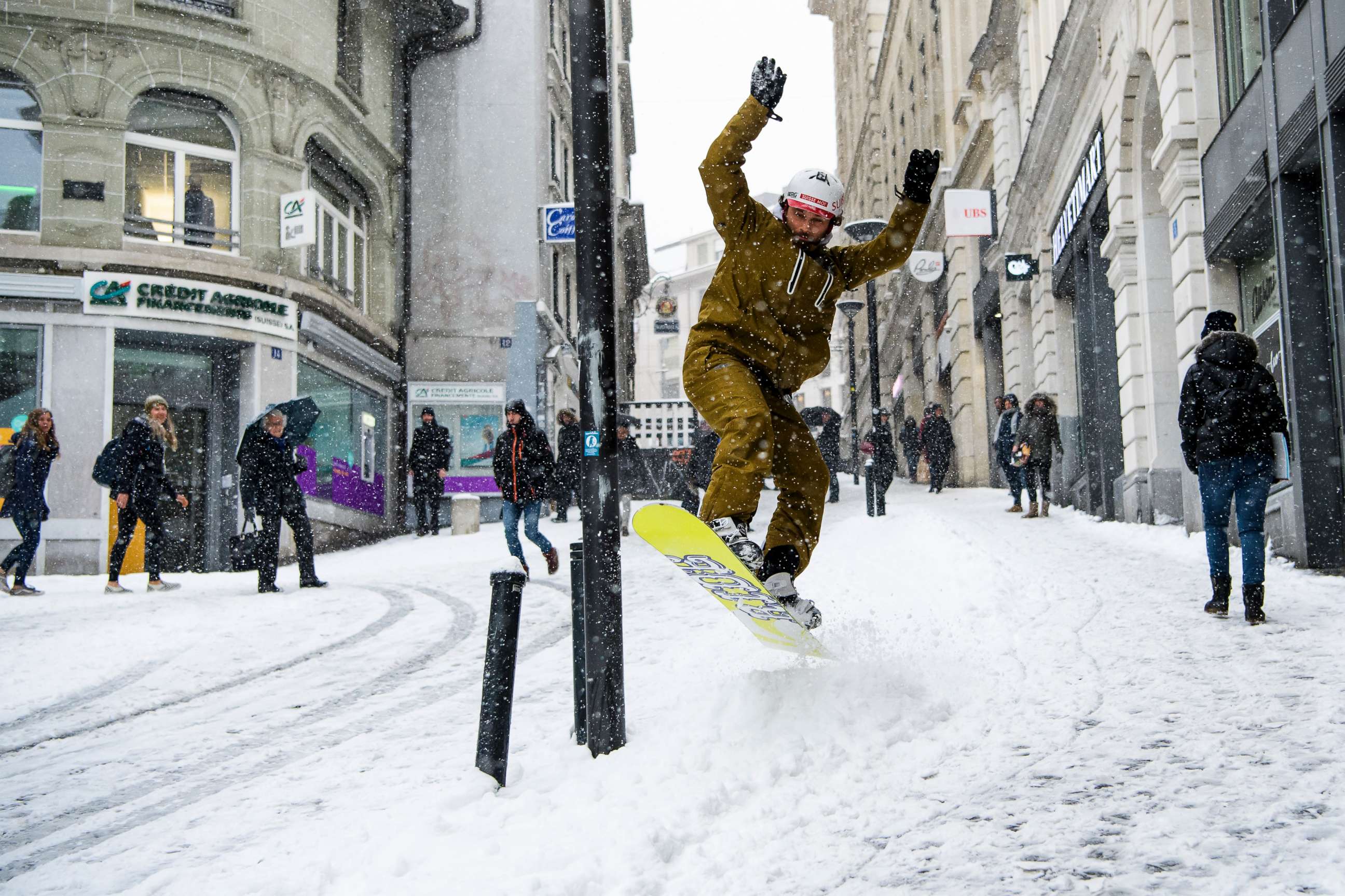 PHOTO: Sylvain rides his snowboard on a snow-covered street during a snowfall in Lausanne, Switzerland, March 1, 2018.