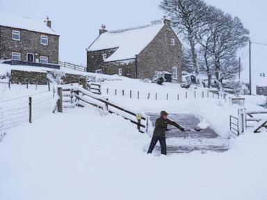 Rain and snow lead to flooding and disrupt travel in parts of the UK