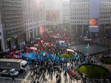 Thousands of workers march across Italy in general strike demanding better pay and services