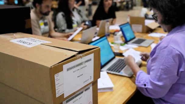 Boxes which arrived from New York and Boston containing votes for Portugal's May 18 general election are stacked on a desk where volunteers are registering them on the final day of counting of ballots from voters who live abroad, in Lisbon, Wednesday, May 28, 2025. (AP Photo/Armando Franca)