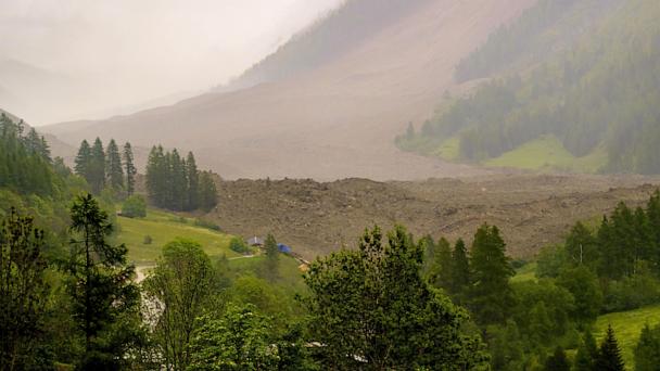A large avalanche with a mixture of ice, rock, snow and water reach the valley floor is pictured in Wiler after the Birch glacier collapsing above Blatten, Switzerland, Wednesday, May 28, 2025. (Jean-Christophe Bott/Keystone via AP)