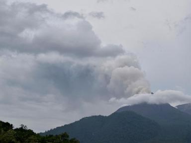 Indonesian rescuers dig through volcanic ash after eruption kills 9