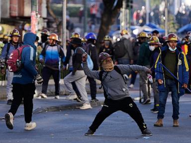 Clashes in Bolivia’s capital as police use tear gas and miners set off dynamite