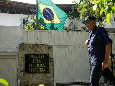 Sheltered Venezuelan government opponents decry police and intelligence agents outside embassy