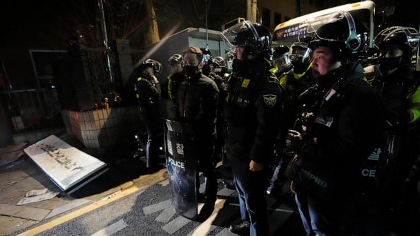 FILE - Police officers stand outside of the Seoul Western District Court after supporters of impeached South Korean President Yoon Suk Yeol broke into the court in Seoul, South Korea on Jan. 19, 2025. (AP Photo/Ahn Young-joon, File)