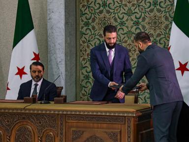 Syrian leader signs constitution that puts the country under an Islamist group's rule for 5 years