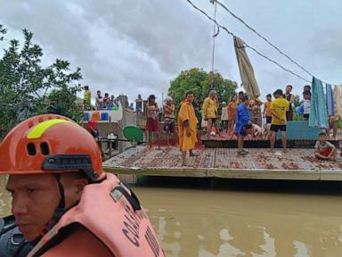 Storm-triggered floods in Philippines spark frantic calls to rescue trapped people, some on roofs