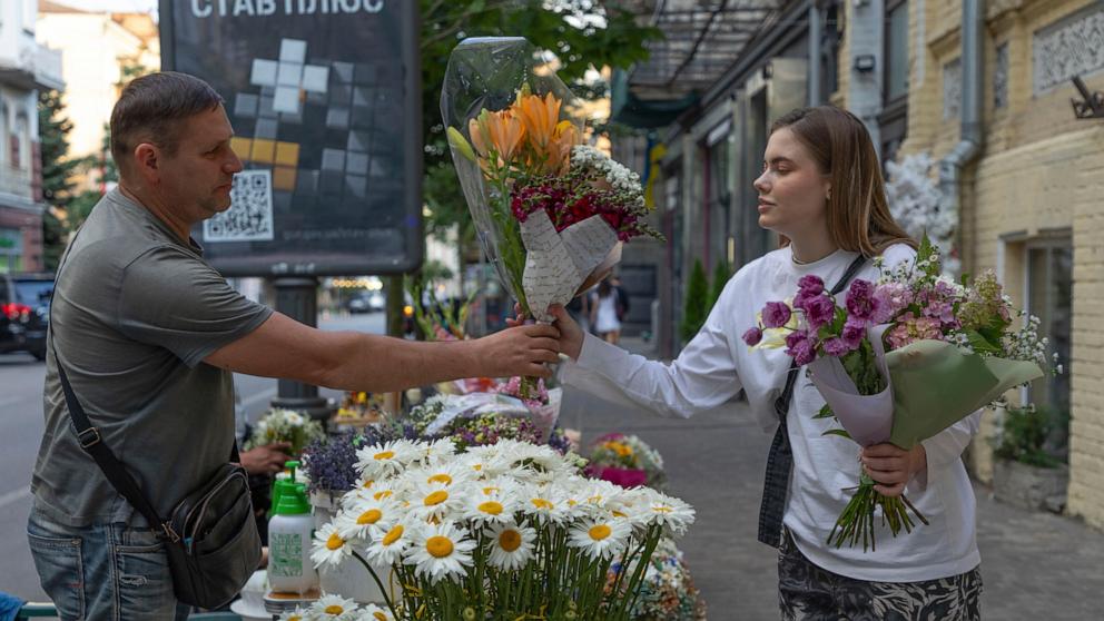 A precious moment in wartime: flowers for a wife and daughter returning home to Ukraine