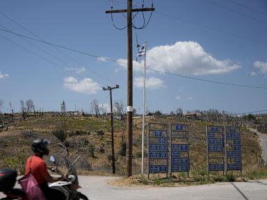 AP PHOTOS: A ferocious blaze scars the land outside Greece’s capital