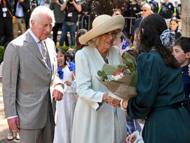 Children greet King Charles III and Queen Camilla outside a Sydney church