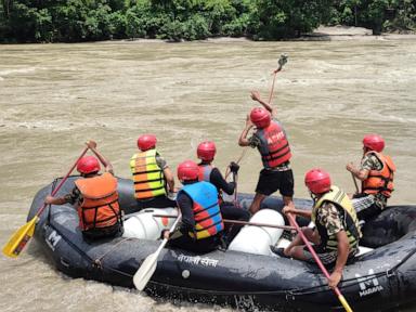 Rescuers in Nepal search for 2 buses swept into river with over 50 people on board