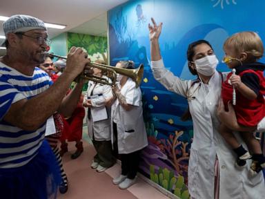 Clowns and musicians bring the joy of Carnival to sick children in a Rio hospital