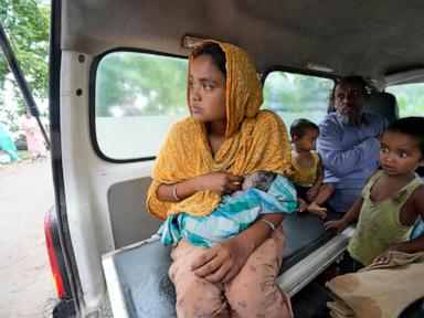 Indian mother delivers baby on boat as her river island is inundated by floodwaters