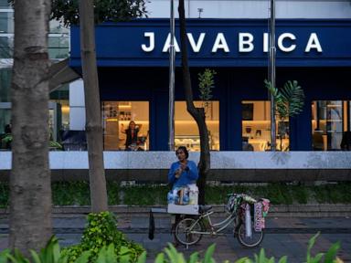 AP PHOTOS: Starlings, Indonesia's bicycle coffee sellers, peddle the streets of Jakarta