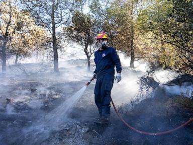 Two wildfires are burning near Greece's capital, fueled by strong winds