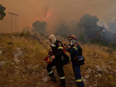 Firefighters scramble to contain fires outside Athens before winds and high temperatures return
