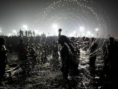 Hindu ascetic rising from the river after a holy dip is emblematic of Maha Kumbh festival in India