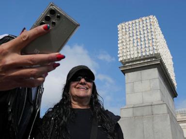 Faces of transgender people adorn an artwork in London’s Trafalgar Square