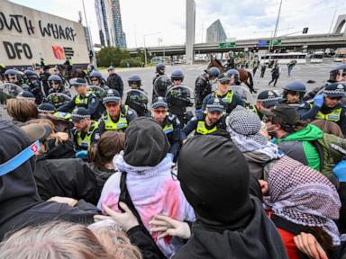 Anti-war protesters in Australia clash with police outside a weapons convention