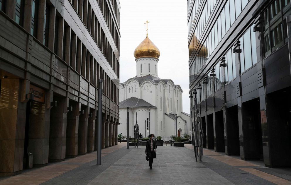 PHOTO: A woman wearing a protective face mask walks in a business district amid the outbreak of the novel coronavirus disease in Moscow, Russia, on May 12, 2020.