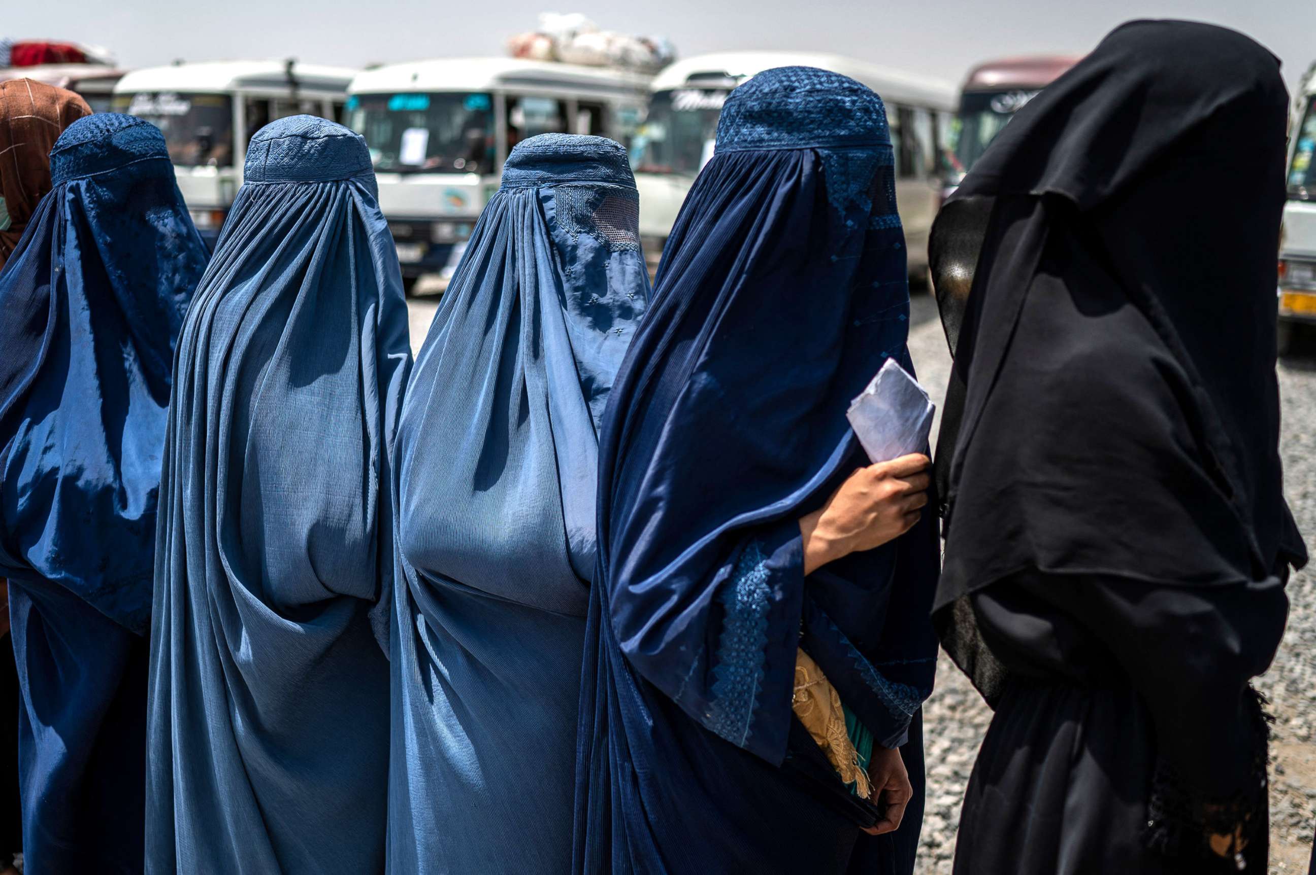 PHOTO: Afghan internally displaced refugee women stand in a queue to identify themselves and receive money as they return home to the east, at the United Nations High Commissioner for Refugees (UNHCR) camp in the outskirts of Kabul on July 28, 2022.