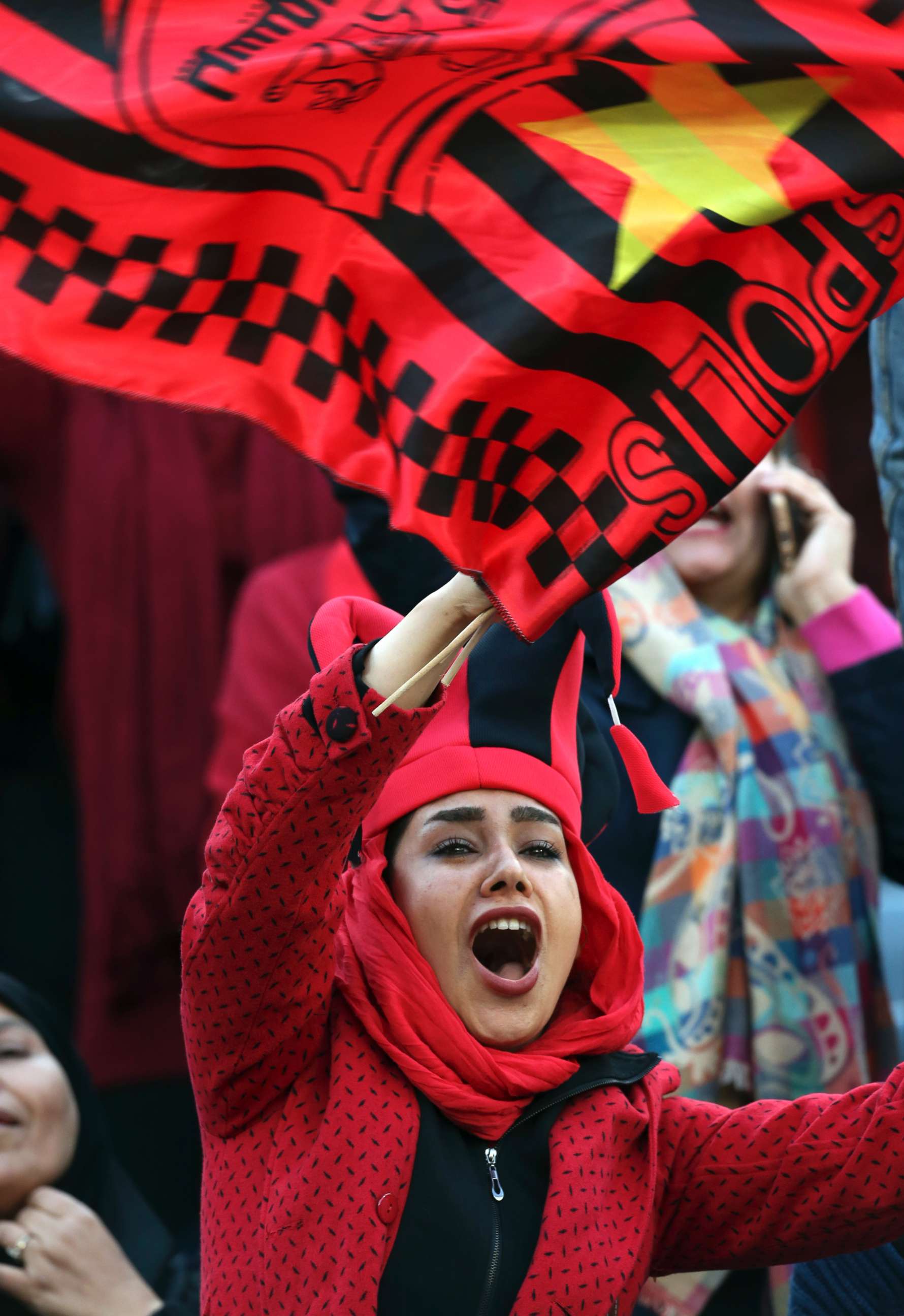 PHOTO: A female Iranian spectator cheers as she waves a flag of Persepolis prior to the start their soccer match with Japan's Kashima Antlers at the Azadi stadium in Tehran, Iran, Nov. 10, 2018.