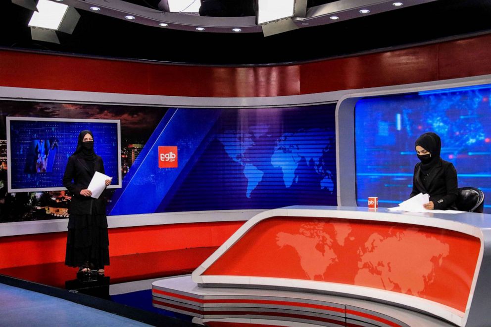 PHOTO: Khatira Ahmadi (L) and Tehmina (R), Afghan presenters at Tolo TV read news at the studio in Kabul, Afghanistan, May 23, 2022.