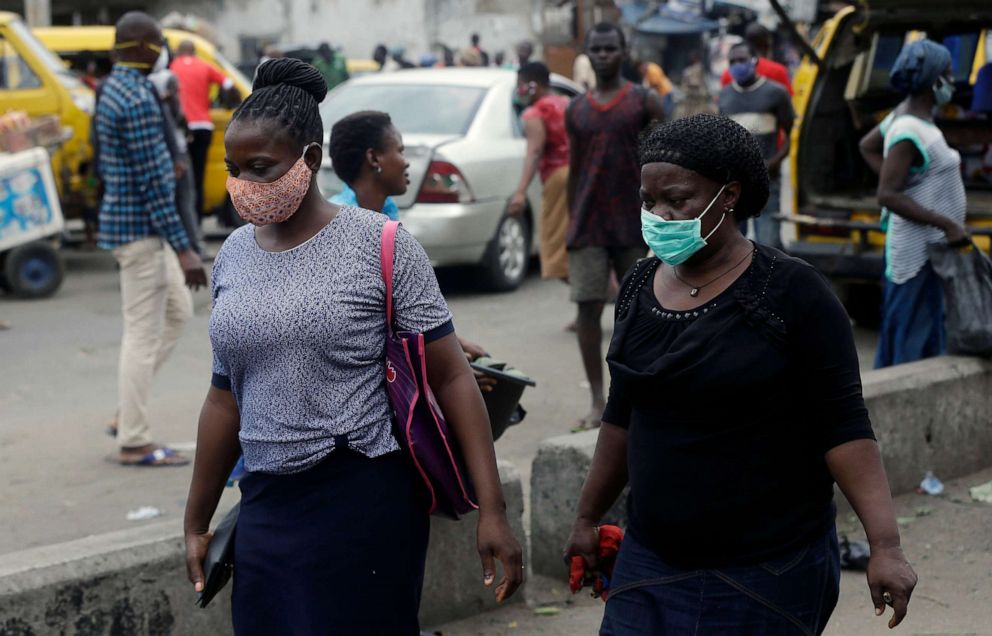 PHOTO: Women wearing face masks to protect themselves from the novel coronavirus walk on a street in Lagos, Nigeria, on May 4, 2020.