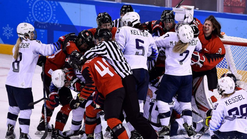 PHOTO: Players pile up on the Canadian goal in the women's preliminary round ice hockey match between the U.S. and Canada during the Pyeongchang Winter Olympic Games at the Kwandong Hockey Centre in Gangneung, Feb. 15, 2018.