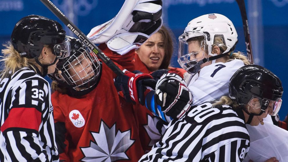 PHOTO: Canada forward Marie-Philip Poulin battles with United States forward Monique Lamoureux-Morando during the third period  of a preliminary round women's hockey game at the 2018 Winter Olympics in Gangneung, South Korea, Feb. 15, 2018.