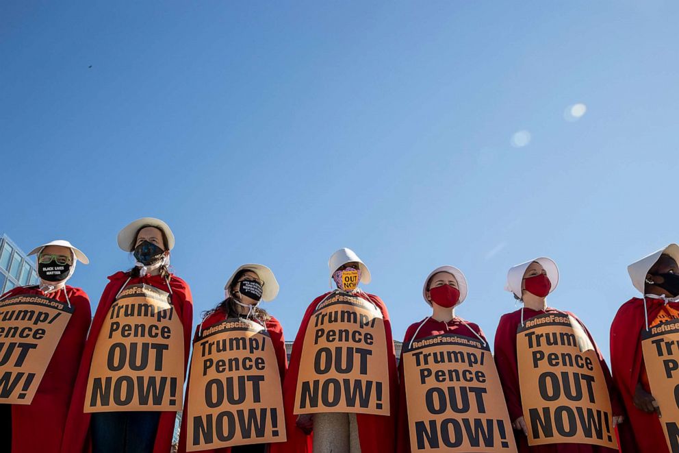 PHOTO: Dressed as handmaids, protesters attend the Women's March at Freedom Plaza on Oct. 17, 2020, in Washington.