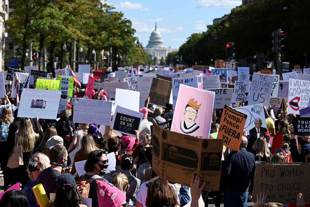 PHOTO: People participate in a nationwide Women's March in honor of the late late Justice Ruth Bader Ginsburg before the 2020 election, in Washington, Oct. 17, 2020.