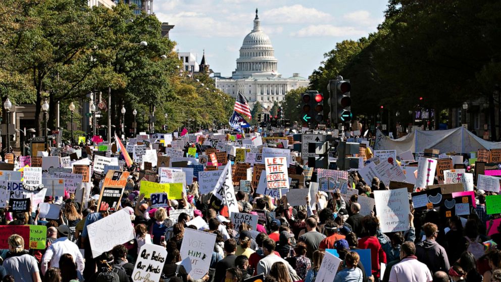 PHOTO: With the U.S Capitol in the background, demonstrators march on Pennsylvania Av. during the Women's March in Washington, Oct. 17, 2020.