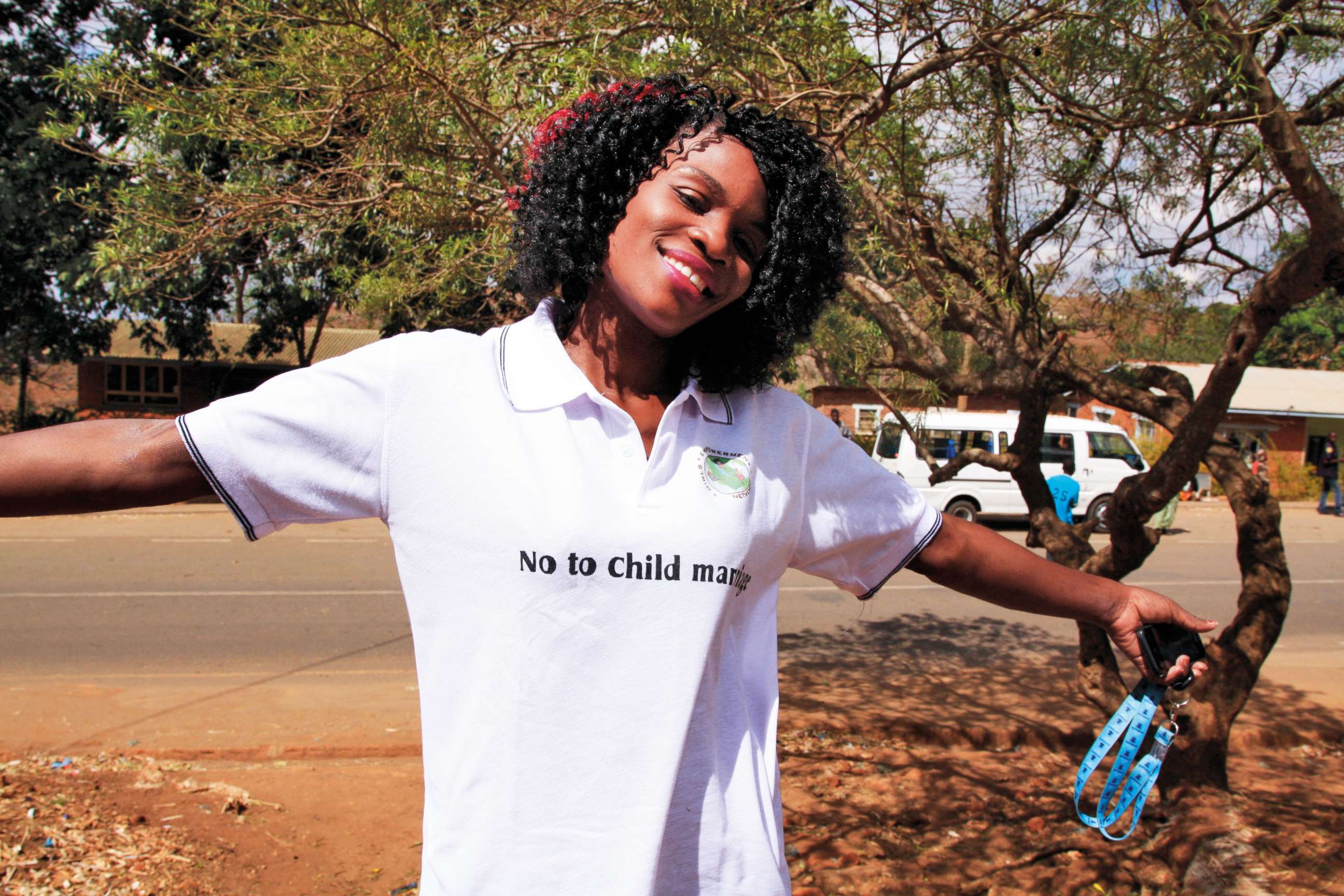 PHOTO: Joyce Mkandawire, co-founder of Girls Empowerment Network (GENET), wears a t-shirt that the girls used to promote their campaign against child marriage, in Malawi.