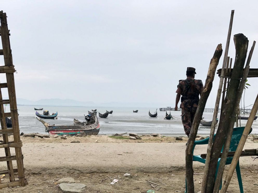 PHOTO: Guards wait on the shores of Bangladesh, at Shah Porir Dwip Island. Rohingya fleeing Myanmar arrive here first.