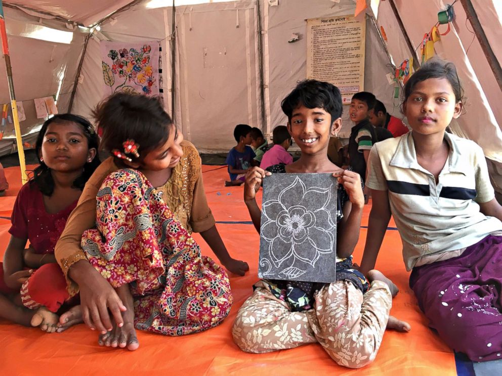 PHOTO: Rohingya children show off artwork at a Save the Children site in Bangladesh.