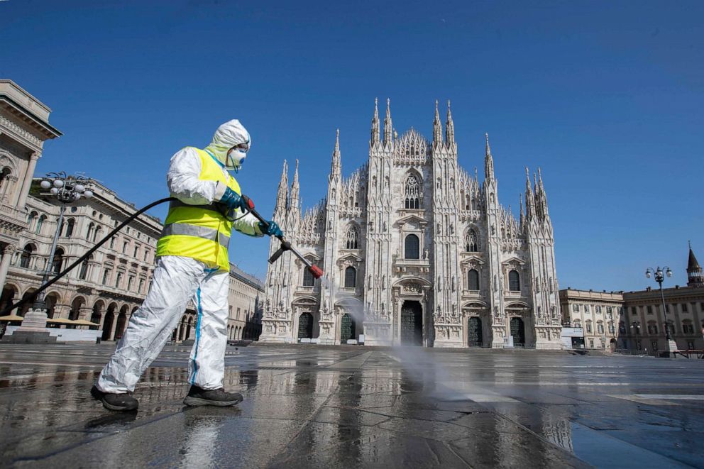 PHOTO: In this file photo taken on March 31, 2020, a worker sprays disinfectant to sanitize Piazza del Duomo, the main city square of Milan, Italy.