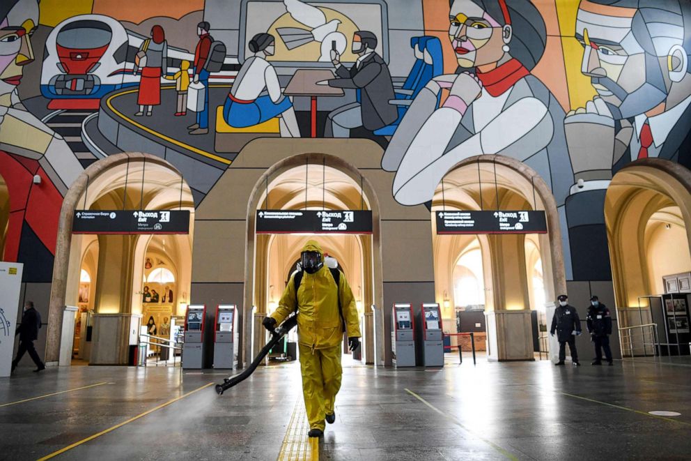 PHOTO: A serviceman of Russia's emergencies ministry wearing protective gear disinfects the Leningradsky railway station in Moscow on May 19, 2020, amid the coronavirus pandemic.