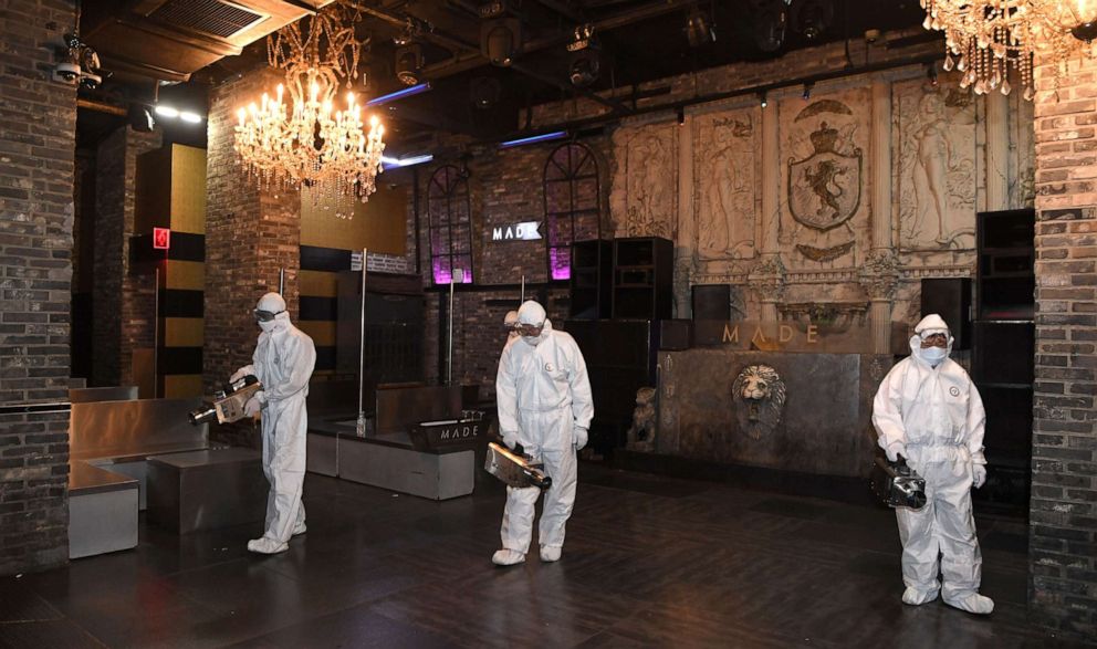 PHOTO: Quarantine workers spray disinfectant at a nightclub in the Itaewon district of Seoul, South Korea, on May 12, 2020, amid an outbreak of the novel coronavirus.