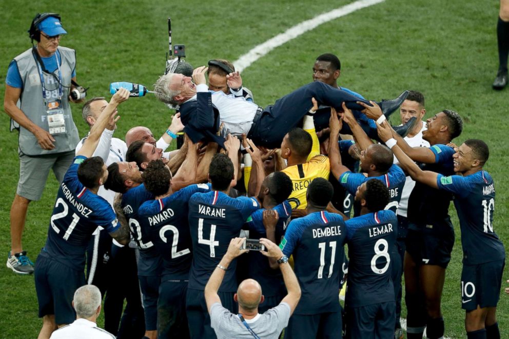 PHOTO: France's players throw France's coach Didier Deschamps, center, into the air after the 2018 World Cup final match between France and Croatia at the Luzhniki Stadium in Moscow, July 15, 2018.