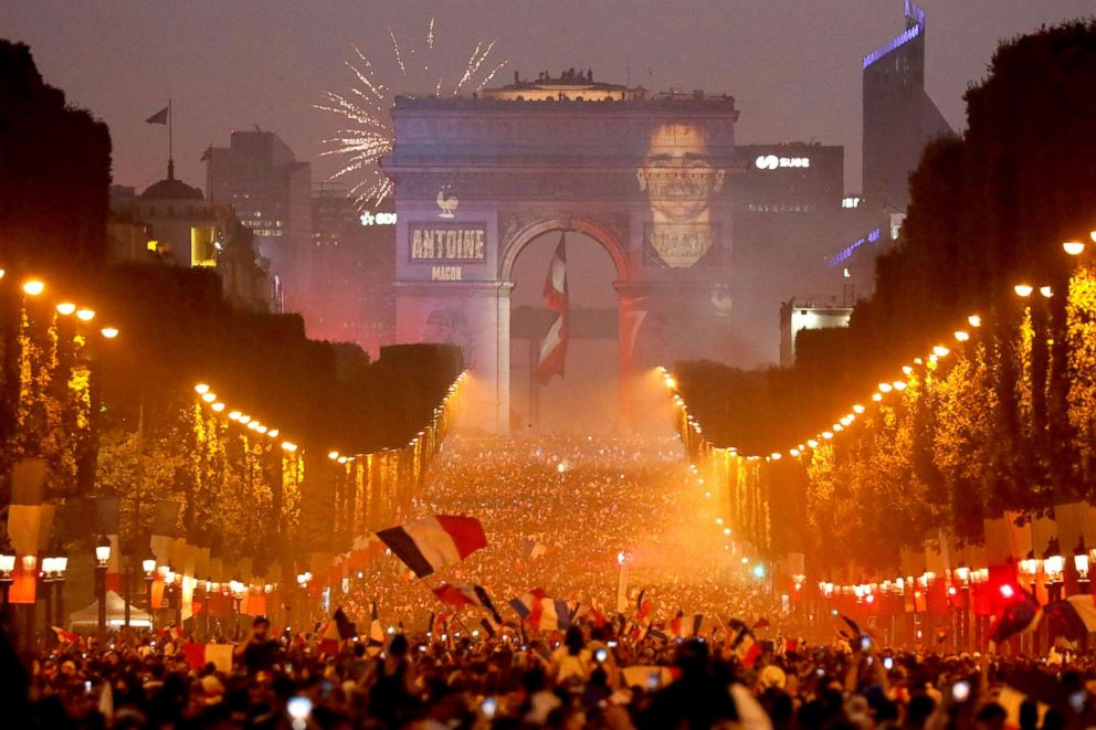 PHOTO: A giant picture of France's Antoine Griezmann is seen on the Arc de Triomphe as France fans celebrate on the Champs-Elysees Avenue after France won the Soccer World Cup final, July 15, 2018, in Paris.