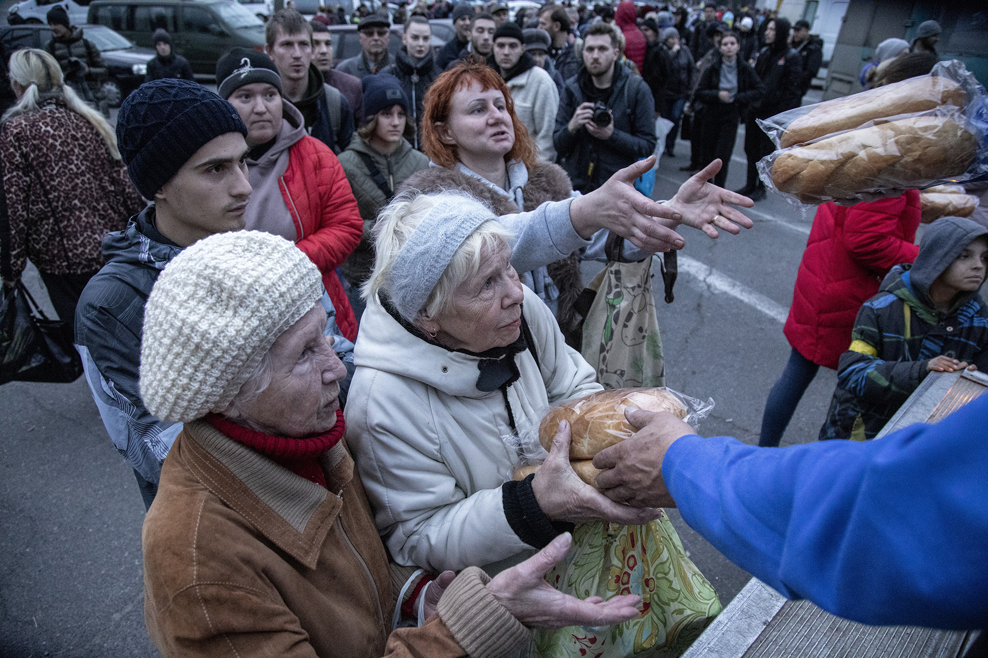 PHOTO: Local civilians queue for food distribution in Kherson City, Ukraine, Nov. 16th, 2022.
