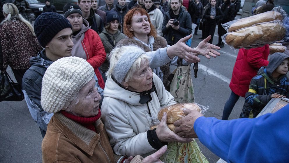 PHOTO: Local civilians queue for food distribution in Kherson City, Ukraine, Nov. 16th, 2022.