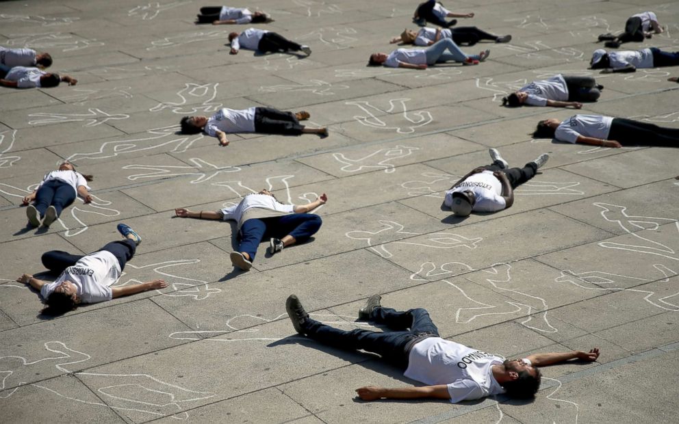 PHOTO: Activists lay on the ground to mark World Refugee Day during a protest in Madrid, June 20, 2018.